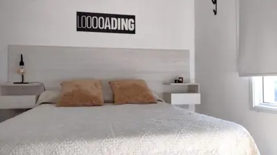 a bedroom with a bed with a sign on the wall at TEMPO GÜEMES Departamento en Güemes, casi Nueva Córdoba in Cordoba