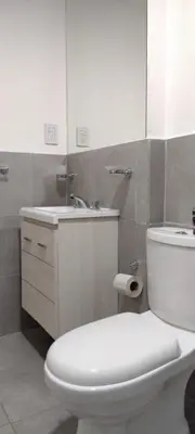 a bathroom with a white toilet and a sink at TEMPO GÜEMES Departamento en Güemes, casi Nueva Córdoba in Cordoba