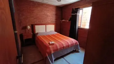 a small bedroom with a bed and a window at Al Pie Del Cerro Champaqui in Los Hornillos