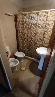 a bathroom with a toilet and a sink at Al Pie Del Cerro Champaqui in Los Hornillos