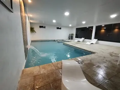 a bathroom with a swimming pool with a sink at AMALGAMA CABAÑAS in Merlo