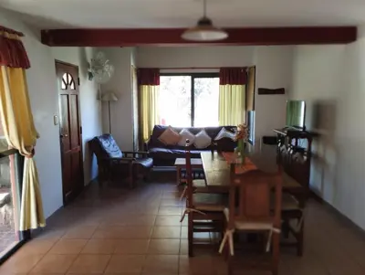 a living room with a couch and a table at AMALGAMA CABAÑAS in Merlo