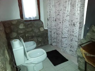 a bathroom with a toilet and a shower curtain at Cielito Lindo in San Javier