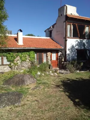 an old house with a red roof and a yard at Cielito Lindo in San Javier
