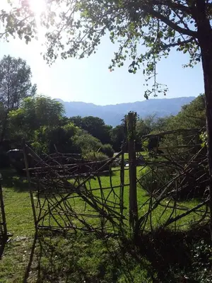 an old wooden fence in a field with a tree at Cielito Lindo in San Javier