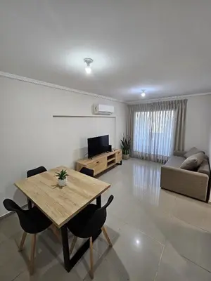 a living room with a table and chairs and a couch at Departamento Terraforte 2 in Cordoba