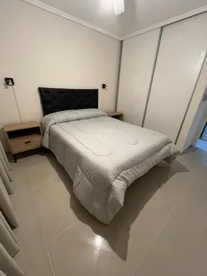 a large bed in a white room with at Departamento Terraforte 2 in Cordoba