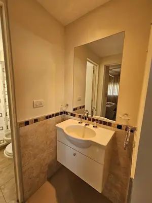 a bathroom with a sink and a mirror at Departamento Terraforte 2 in Cordoba