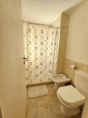 a bathroom with a toilet and a shower at Departamento Terraforte 2 in Cordoba