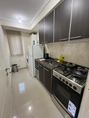 a kitchen with a stove and a refrigerator at Departamento Terraforte 2 in Cordoba