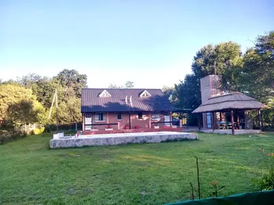 a house with a large yard and a gazebo at Los Laureles de Sorso in Villa Ciudad Parque