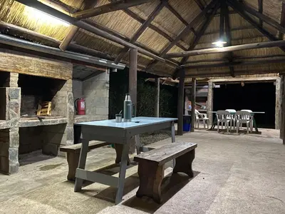 a ping pong table and a bench in a building at Los Laureles de Sorso in Villa Ciudad Parque