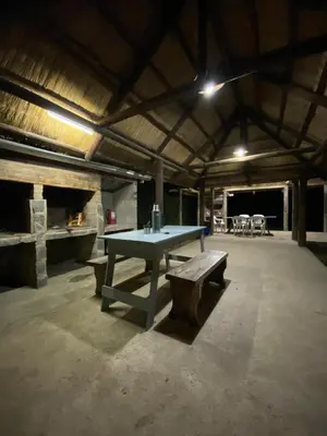 a ping pong table and a bench in a building at Los Laureles de Sorso in Villa Ciudad Parque