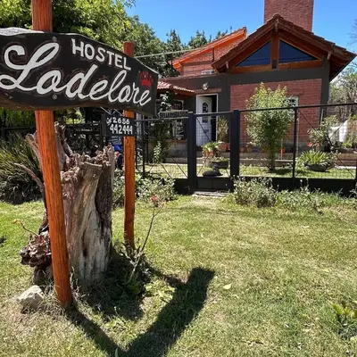 a sign for a hostelel laureate in front of a house at Lodelore in Merlo