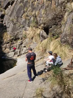 a group of people sitting on the side of a mountain at Lodelore in Merlo