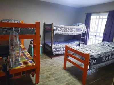 a room with two bunk beds and a chair at Lodelore in Merlo