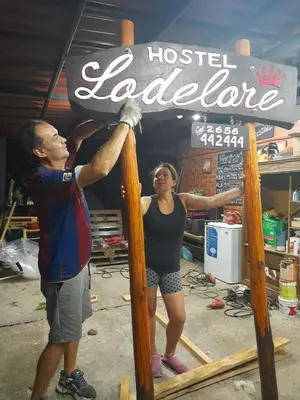 a man and a woman standing under a sign at Lodelore in Merlo