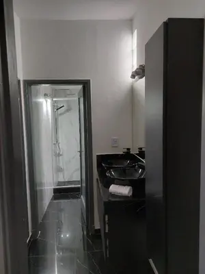 a bathroom with a shower and a black sink at RaGi dpto 3 in Cordoba