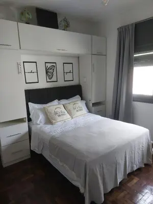 a bedroom with a white bed with two pillows at RaGi dpto 3 in Cordoba