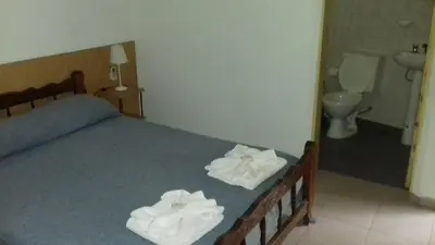 a bedroom with a bed with two towels on it at Posada A Lo De Santys in Villa Independencia