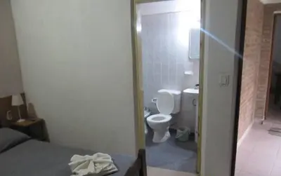 a room with a bathroom with a toilet and a sink at Posada A Lo De Santys in Villa Independencia