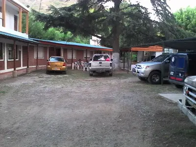 a group of vehicles parked in front of a building at Posada A Lo De Santys in Villa Independencia