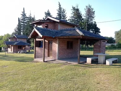 a small brick building with a bench in a field at Un lugar en el Mundo in Villa Amancay