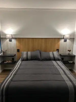 a large bed in a room with two lamps at La cumbrecita ,Casitas super lujo in La Cumbrecita