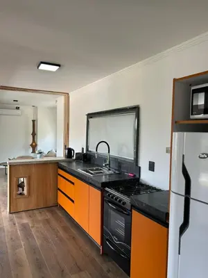 a kitchen with a sink and a stove top oven at La cumbrecita ,Casitas super lujo in La Cumbrecita