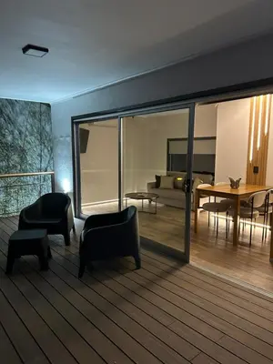 a living room with black chairs and a table at La cumbrecita ,Casitas super lujo in La Cumbrecita