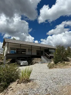 a house with a car parked in front of it at La cumbrecita ,Casitas super lujo in La Cumbrecita