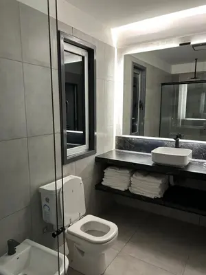 a bathroom with a toilet and a sink and a mirror at La cumbrecita ,Casitas super lujo in La Cumbrecita