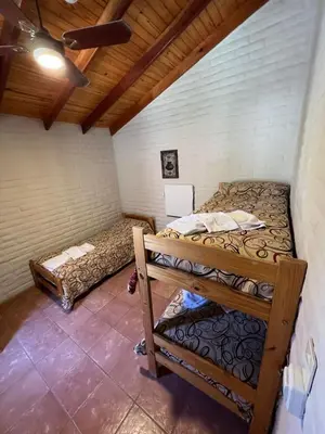 a bedroom with two bunk beds in a room at Altos de Brochero Cabañas & Padel in Villa Cura Brochero