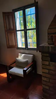 a living room with a chair and a window at Mística in Alta Gracia