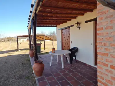a patio with a white table and chairs on it at Las Masias de Nono in Nono