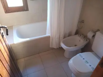 a bathroom with a toilet and a tub and a sink at Las Masias de Nono in Nono