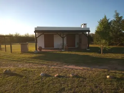 a small building in a field with rocks in the grass at Las Masias de Nono in Nono