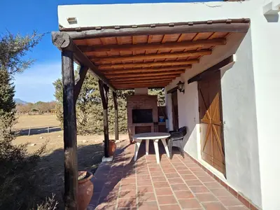 a patio with a table and a wooden pergola at Las Masias de Nono in Nono