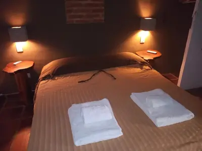 a bedroom with a bed with two towels on it at Las Masias de Nono in Nono