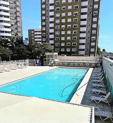 a large swimming pool in front of a tall building at Villasol TOP in Cordoba