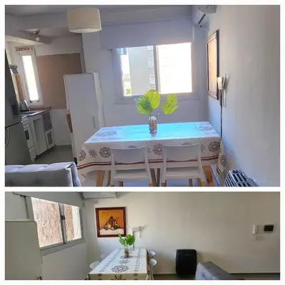 a kitchen and a dining room with a table in a room at Villasol TOP in Cordoba