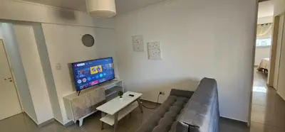 a living room with a couch and a tv at Villasol TOP in Cordoba