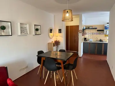 a dining room and kitchen with a table and chairs at Alma mia in Villa Carlos Paz
