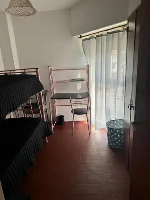 a room with a chair and a table and a window at Alma mia in Villa Carlos Paz