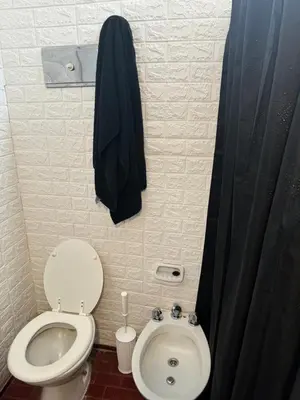 a small bathroom with a toilet and a sink at Alma mia in Villa Carlos Paz