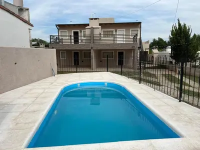 a swimming pool in front of a house at La Nonita in Villa Carlos Paz