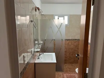 a bathroom with a sink and a shower at La Nonita in Villa Carlos Paz