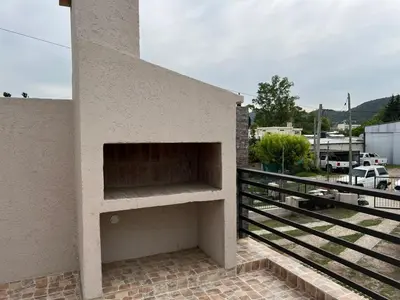 a fireplace on the side of a building at La Nonita in Villa Carlos Paz
