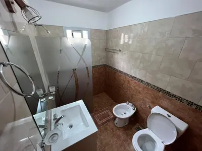 a bathroom with a toilet and a sink at La Nonita in Villa Carlos Paz
