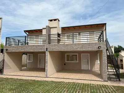 a house with a balcony on top of it at La Nonita in Villa Carlos Paz